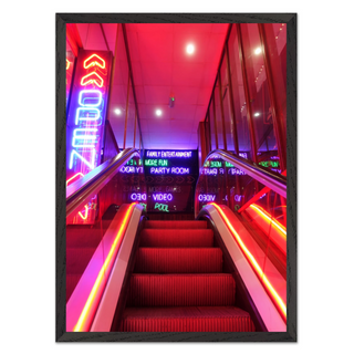 Vibrant urban wall art print of a neon-lit staircase with colorful lights and signage, designed for modern city interiors and displayed in a premium black wooden frame.