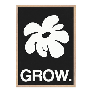 Framed artwork featuring a white abstract leaf design and the word 'GROW.' on a black background, displayed in a premium oak wooden frame.