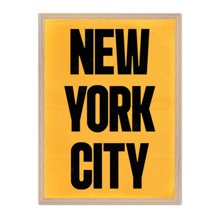 Urban New York poster with black text 'New York City' on a yellow background. Displayed in a premium wooden oak frame.
