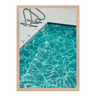 Framed photograph of a turquoise blue pool with clear water, displayed in a premium oak wooden frame.