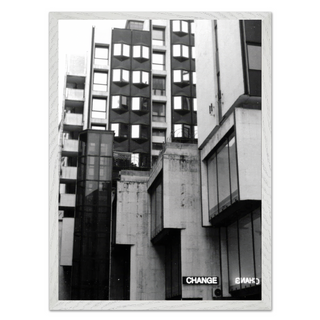 Black and white photographic art print featuring a Brutalist architecture cityscape with bold geometric shapes and industrial design elements. The photograph presents striking contrasts and shadows in an urban environment, offering a modern and contemporary visual style. Ideal for home decor, this print brings a sense of modernity and architectural elegance to living spaces. Perfect for those who appreciate unique urban photography and minimalist design aesthetics, reflecting the character of