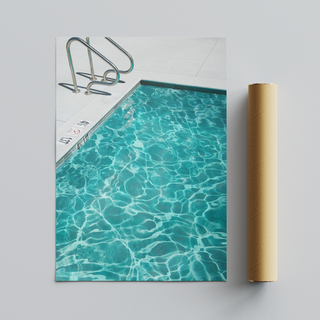 Framed photograph of a turquoise blue pool with clear water, displayed next to brown cardboard packaging tube roll.