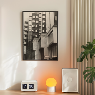 Black and white photographic art print featuring a Brutalist architecture cityscape with bold geometric shapes and industrial design elements. The photograph presents striking contrasts and shadows in an urban environment, offering a modern and contemporary visual style. Ideal for home decor, this print brings a sense of modernity and architectural elegance to living spaces. Perfect for those who appreciate unique urban photography and minimalist design aesthetics, reflecting the character of