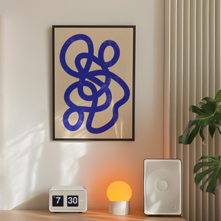 Abstract artwork featuring a bold blue design on a beige background, displayed in a premium black wooden frame, perfect for modern and minimalist wall decor.