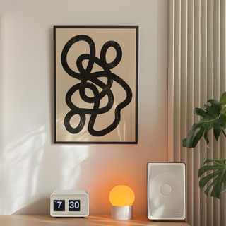 Minimalist artwork featuring a black interwoven design on a beige background, displayed in a premium black wooden frame.