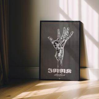 Black and white illustration of a melting silver hand on a black background with 'Innk Studios' branding in white text. Displayed in a black wooden frame.
