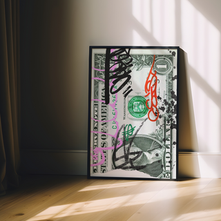 Framed artwork of a one-dollar bill with graffiti-style text on a wooden surface.