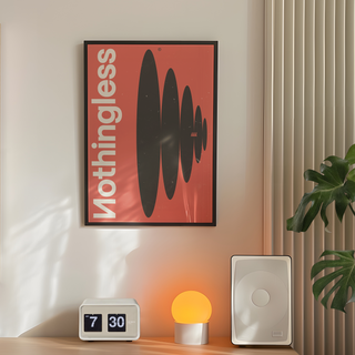 Framed poster featuring the word 'Nothingless' with black abstract shapes on a red background, displayed in a premium black wooden frame. Placed in bedroom wall next to plant, speakers and lamp.