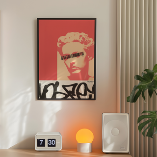 Graffiti red black and white poster featuring a sculpture face of a woman stylized. Graffiti style marks. Displayed in a black wooden frame. Placed in minimalist bedroom next to plant, speakers and lamp.