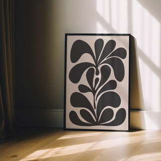 Bold abstract black floral botanical pattern illustration on beige background displayed in a premium black wooden frame.