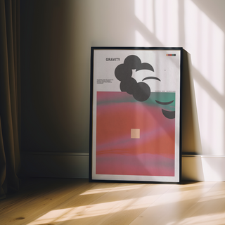 Abstract poster with pink and green hues, bold typography reading ‘Gravity’ on a clean white background, displayed in a premium wooden black frame.