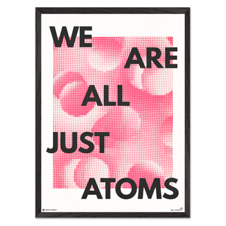 Framed poster with text 'WE ARE ALL JUST ATOMS' on a pink and white abstract background.