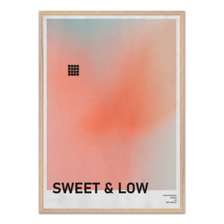 Urban typography poster with gradient peach design and text 'SWEET & LOW'. Displayed in a oak wooden frame. 
