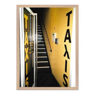 Urban 35mm film photograph of a taxi service front door with an edgy street art aesthetic, displayed in a premium oak wooden frame.