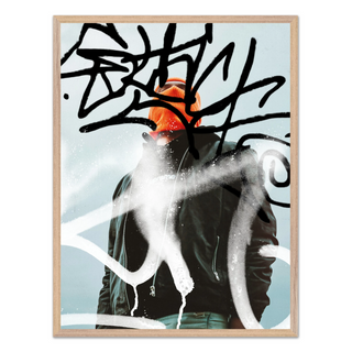 Urban photography of man wearing an orange beanie and black jacket with abstract art graffiti elements on a light blue background. Displayed in a oak wooden frame. 
