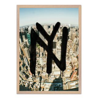 Framed urban artwork featuring New York graffiti over a cityscape, displayed in a premium oak wooden frame.