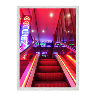 Vibrant urban wall art print of a neon-lit staircase with colorful lights and signage, designed for modern city interiors and displayed in a premium white wooden frame.