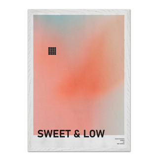 Urban typography poster with gradient peach design and text 'SWEET & LOW'. Displayed in a white wooden frame. 