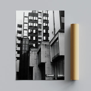 Black and white photographic art print featuring a Brutalist architecture cityscape with bold geometric shapes and industrial design elements. The photograph presents striking contrasts and shadows in an urban environment, offering a modern and contemporary visual style. Ideal for home decor, this print brings a sense of modernity and architectural elegance to living spaces. Perfect for those who appreciate unique urban photography and minimalist design aesthetics, reflecting the character of
