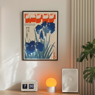 Red bold Japanese inspired typography with blue orchids illustration poster displayed in a black premium wooden frame. Place on a wall in a minimal bedroom next to plant, speakers and lamp. 