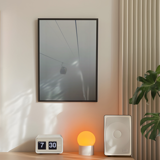 Framed photograph capturing a cable car in misty, foggy conditions, displayed in a premium black wooden frame.