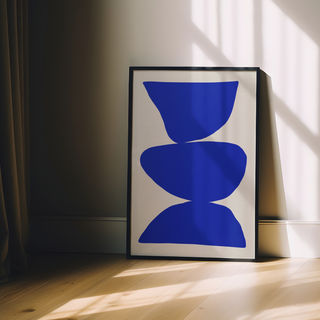 Cobalt blue abstract art with blue shapes on a beige background. Displayed in a black wooden frame. 