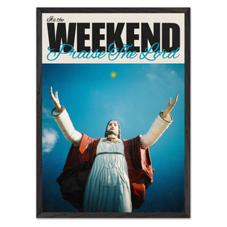 Bold typography poster with a religious figure Jesus with arms outstretched against a blue sky, text 'It's the Weekend Praise The Lord' at the top. Displayed in a premium black wooden frame. 