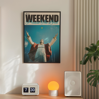 Bold typography poster with a religious figure Jesus with arms outstretched against a blue sky, text 'It's the Weekend Praise The Lord' at the top. Displayed in a premium black wooden frame.  Placed on a wall in a bedroom next to plant, speakers and lamp. 