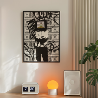 Urban banksy inspired graffiti wall art featuring dollar bills as the background a figure of a man with a tv on his head with cash inside. Thought provoking street urban poster. Displayed in a premium black wooden frame.  Placed on a bedroom wall next to a plant, lamp and speakers. 