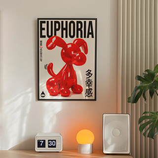 Bold Japanese style exhibition poster of  red balloon dog sculpture with 'Euphoria' text on a white background. Displayed in a black premium wooden frame. Placed on a wall in a bedroom next to plant, lamp and speakers. 