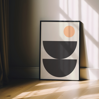 Boho scandi style abstract art print with black semi circle shapes and a peach circle on a beige background. Displayed in a premium wood black frame. 