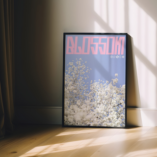 Lilac and pink graphic design poster with cherry blossoms and 'Blossom' text. Displayed in a premium wooden black frame. 