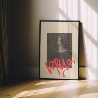 Vintage sepia photograph of nude lady with red graffiti mark overlaid placed on beige background poster. Displayed in a premium black wooden frame. 